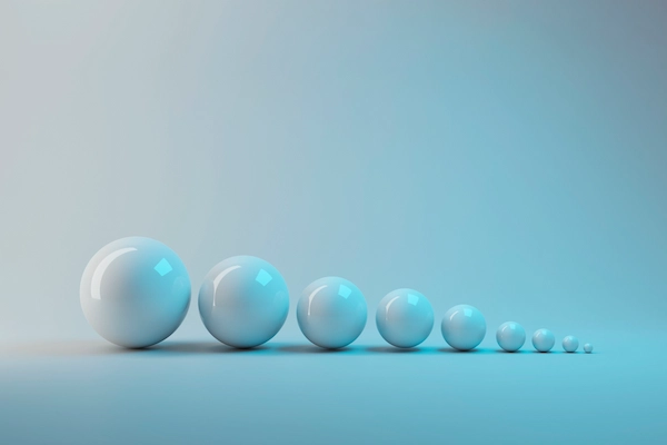 a row of white spheres from large to small