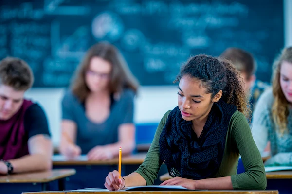 student working on high school algebra and geometry school work